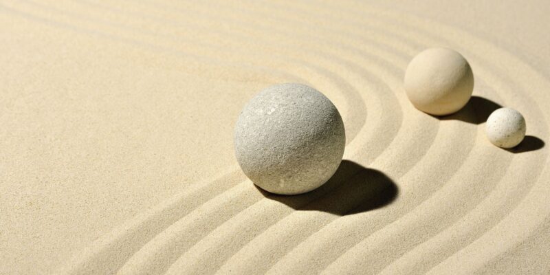 Three balls in sand, like a zen garden.